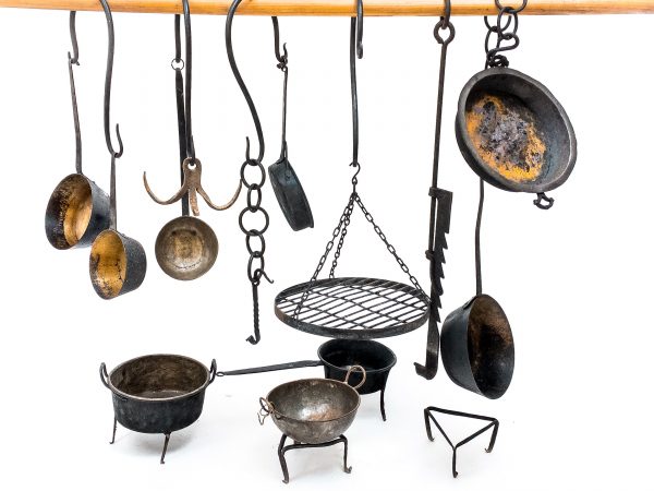 Medieval iron chains and hooks with medieval kitchen pots and medieval kitchen accessories for medieval kitchen or witchraft