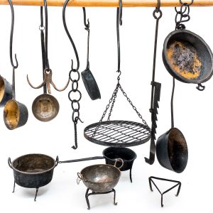 Medieval iron chains and hooks with medieval kitchen pots and medieval kitchen accessories for medieval kitchen or witchraft